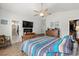 A comfortable main bedroom includes an en suite bathroom, walk-in closet, and wood furniture at 1833 Lake Egret Dr., North Myrtle Beach, SC 29582