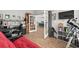 Office showcasing a red futon and telescope, with a view of the kitchen through glass doors at 1833 Lake Egret Dr., North Myrtle Beach, SC 29582