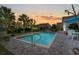 Inviting pool at dusk, featuring a brick patio, lush landscaping, and tranquil atmosphere for relaxation and enjoyment at 1833 Lake Egret Dr., North Myrtle Beach, SC 29582