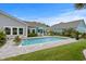 Backyard features a sparkling in-ground swimming pool with patio, lounge chairs, and well-maintained lawn at 1833 Lake Egret Dr., North Myrtle Beach, SC 29582