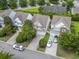 An aerial view shows the home nestled in a neighborhood with manicured lawns and tree-lined streets at 185 Fulbourn Pl., Myrtle Beach, SC 29579