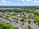 An aerial view pinpoints the home in a lush, green community with mature trees and winding roads at 185 Fulbourn Pl., Myrtle Beach, SC 29579