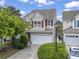 Charming two-story home featuring a two-car garage, well-manicured lawn, and red shutters adding a pop of color at 185 Fulbourn Pl., Myrtle Beach, SC 29579
