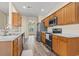 Well-equipped kitchen with stainless steel appliances, wood cabinets, and sleek countertops at 185 Fulbourn Pl., Myrtle Beach, SC 29579