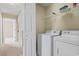 Convenient laundry room featuring a modern washer and dryer, with ample shelving for storage and organization at 185 Fulbourn Pl., Myrtle Beach, SC 29579