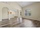 Spacious living room featuring vaulted ceilings, hardwood floors, and natural light, seamlessly connecting to the kitchen area at 185 Fulbourn Pl., Myrtle Beach, SC 29579