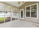 A cozy screened porch offers a ceiling fan and access to a well-kept backyard, perfect for relaxation at 185 Fulbourn Pl., Myrtle Beach, SC 29579