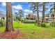 Backyard view of home with sun room and large trees in the background at 1880 Plantation Dr., Myrtle Beach, SC 29577