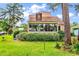 Lush backyard view of home featuring a sunroom, green grass, and beautiful trees at 1880 Plantation Dr., Myrtle Beach, SC 29577