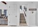 Hallway with staircase, coat closet, and view to living room with comfortable seating at 1880 Plantation Dr., Myrtle Beach, SC 29577