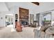 Bright living room with large brick fireplace, comfortable seating, and natural light at 1880 Plantation Dr., Myrtle Beach, SC 29577