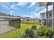 Landscaped backyard with black fencing, lush greenery, and scenic neighborhood views at 2080 Silver Island Way, Murrells Inlet, SC 29576