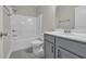 Bright bathroom with shower, tub, and a gray vanity with storage at 2080 Silver Island Way, Murrells Inlet, SC 29576