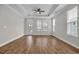Spacious bedroom featuring tray ceilings, a ceiling fan, hardwood floors, and abundant natural light at 2080 Silver Island Way, Murrells Inlet, SC 29576