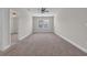 Spacious bonus room featuring neutral carpet, large windows, and ceiling fan at 2080 Silver Island Way, Murrells Inlet, SC 29576