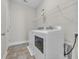 Laundry room with washer, dryer, wire shelving, and tiled floor at 2080 Silver Island Way, Murrells Inlet, SC 29576