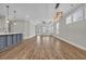 Bright, open living space with elegant lighting fixtures, hardwood floors, and a view of the outdoor patio at 2080 Silver Island Way, Murrells Inlet, SC 29576