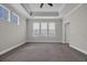 Spacious main bedroom featuring tray ceiling, large windows, and neutral carpet at 2080 Silver Island Way, Murrells Inlet, SC 29576