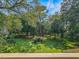 Serene backyard view featuring lush green lawns and mature trees, creating a private and peaceful outdoor space at 210 Westleton Dr. # 13-D, Myrtle Beach, SC 29572