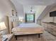 Bedroom featuring a comfortable bed, TV, and views of the tree lined property at 210 Westleton Dr. # 13-D, Myrtle Beach, SC 29572