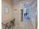 Well-lit hallway with mirrored decor and console table that provides passage to the kitchen and living spaces at 210 Westleton Dr. # 13-D, Myrtle Beach, SC 29572