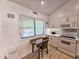 Bright kitchen features a breakfast nook, white cabinets, and tiled backsplash at 210 Westleton Dr. # 13-D, Myrtle Beach, SC 29572