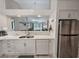 The kitchen has white cabinets and flows into the living area with stainless appliances at 210 Westleton Dr. # 13-D, Myrtle Beach, SC 29572
