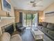 Well-decorated living room with a fireplace, cozy seating, and a sliding door leading to an outdoor balcony at 210 Westleton Dr. # 13-D, Myrtle Beach, SC 29572