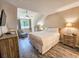 Bright, spacious bedroom features wood-look floors, a ceiling fan, and an oversized window at 210 Westleton Dr. # 13-D, Myrtle Beach, SC 29572