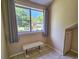 Cozy sitting room with large window that provides views to the outdoors and a built in bench at 210 Westleton Dr. # 13-D, Myrtle Beach, SC 29572