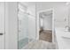 Stylish bathroom featuring a double vanity with a modern glass shower and a view into an adjacent bedroom at 218 Calhoun Falls Dr., Myrtle Beach, SC 29579