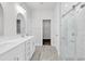 Bright, modern bathroom featuring double vanity, glass enclosed shower and walk-in closet at 218 Calhoun Falls Dr., Myrtle Beach, SC 29579
