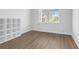 Bright bedroom with wood floors, a large window, and a white shelf at 218 Calhoun Falls Dr., Myrtle Beach, SC 29579