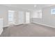 Large room featuring neutral carpeting, multiple doors, and a window at 218 Calhoun Falls Dr., Myrtle Beach, SC 29579