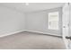 A simple bedroom with neutral carpeting, a window, and white trim at 218 Calhoun Falls Dr., Myrtle Beach, SC 29579