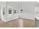 Bright dining area featuring large windows, light hardwood floors, and an open floor plan to the kitchen at 218 Calhoun Falls Dr., Myrtle Beach, SC 29579