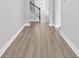 Inviting hallway featuring hardwood floors and staircase with rod iron details at 218 Calhoun Falls Dr., Myrtle Beach, SC 29579