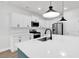 Bright kitchen boasts a large island with modern faucet, stainless appliances, and white cabinetry at 218 Calhoun Falls Dr., Myrtle Beach, SC 29579