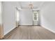 Open living room with stylish light fixture, neutral walls, and lots of natural light from the surrounding windows at 218 Calhoun Falls Dr., Myrtle Beach, SC 29579