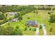 An aerial view of a red brick house with large lawns and mature trees around the home at 2191 Jasmine Rd., Loris, SC 29569