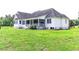 A charming two-story home with light siding and a screened-in porch situated on a vast lawn at 2191 Jasmine Rd., Loris, SC 29569