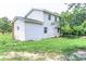 Two-story home with white siding, surrounded by mature trees and a sprawling green lawn at 2191 Jasmine Rd., Loris, SC 29569
