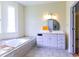 Bathroom featuring a soaking tub, large mirror, vanity, and bright light fixtures at 2191 Jasmine Rd., Loris, SC 29569