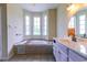 Bathroom featuring a soaking tub, tiled backsplash, and light-colored vanity at 2191 Jasmine Rd., Loris, SC 29569