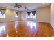 Large bonus room with hardwood floors, windows and ceiling fans at 2191 Jasmine Rd., Loris, SC 29569