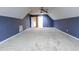 Large bonus room with carpeted floors, dormered ceiling and a doorway into the bathroom at 2191 Jasmine Rd., Loris, SC 29569