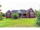 A charming brick home featuring a covered front porch and manicured green lawn at 2191 Jasmine Rd., Loris, SC 29569