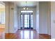 Welcoming foyer showcasing hardwood floors, a modern light fixture and a glass front door at 2191 Jasmine Rd., Loris, SC 29569