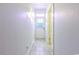 Bright hallway features tiled flooring, a side door, and a door with transom window for natural light at 2191 Jasmine Rd., Loris, SC 29569