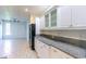 Bright kitchen with white cabinets, granite countertops and black appliances open to living space at 2191 Jasmine Rd., Loris, SC 29569